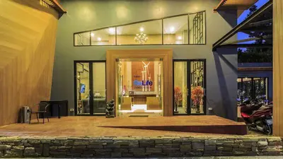 a front door of a house with a motorcycle outside at Relife Windy by Nataly in Phuket Town