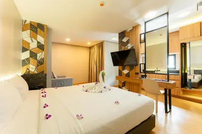 a hotel room with a bed with flowers on it at Sky Wave Patong in Patong Beach