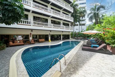 a swimming pool in front of a building at Patong Central Residence and Apartment in Patong Beach