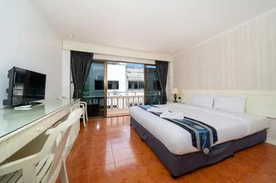 a hotel room with a large bed and a television at Patong Central Residence and Apartment in Patong Beach