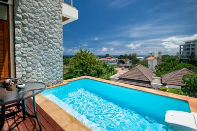 a swimming pool on the deck of a house at Prima Villas Karon Phuket in Karon Beach