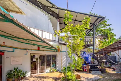 a building with plants in front of it at Baan Kim Lian SHA in Phuket Town