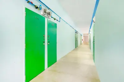 a row of green lockers in a hallway at Baan Kim Lian SHA in Phuket Town