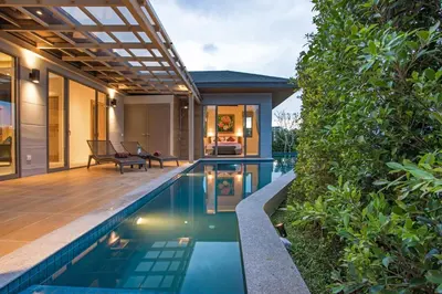 an infinity pool in a backyard with a house at Modern Pool Villa Dalaa 7 in Kamala Beach