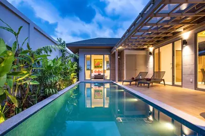 a villa with a swimming pool and a house at Beach escape at Villa Dalaa 8 in Kamala Beach