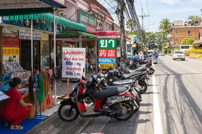 a row of motorcycles parked on the side of a street at Palmetto by Holy Cow, 2-BR, Sea View in Karon Beach