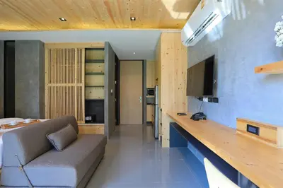 a living room with a couch and a counter at Relife Windy by Holy Cow, studio with sofa-bed in Rawai Beach