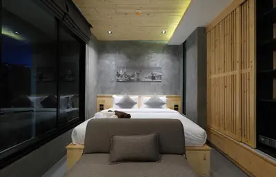 a bedroom with a large bed and a chair at Relife Windy by Holy Cow, studio with sofa-bed in Rawai Beach