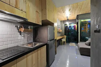 a kitchen with a stainless steel refrigerator and a sink at Relife Windy by Holy Cow, studio with sofa-bed in Rawai Beach