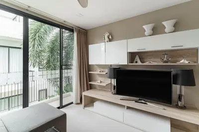a living room with a tv and a large window at 5bdr Pool Villa In Laguna Park #46 By Capital Pro in Bang Tao Beach