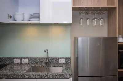 a kitchen with a stainless steel refrigerator and white cabinets at 1bdr Pool Access Apartment Bangtao #5103 in Bang Tao Beach