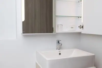 a bathroom with a white sink and a mirror at 1bdr Pool Access Apartment Bangtao #5104 in Bang Tao Beach