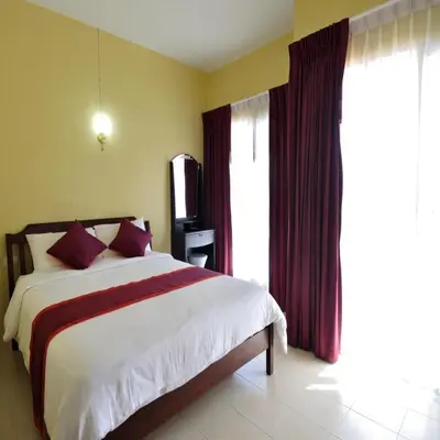 a bedroom with a bed and a large window at Serene Villa Phuket in Chalong