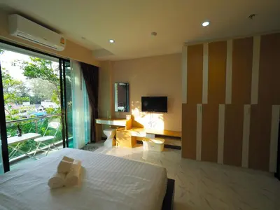 a hotel room with a bed with two towels at Pak Dee At Naithon in Nai Thon Beach