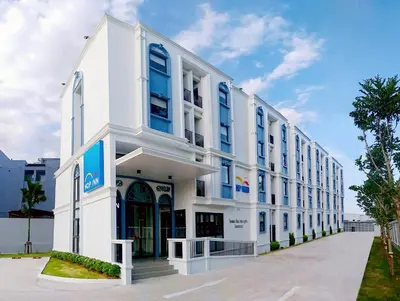 a white building with blue windows at HOP INN Phuket Old Town in Phuket Town