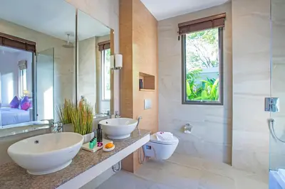 a bathroom with two sinks and a toilet at Boutique Resort 2BR Pool Villa Dalaa 2, Kamala Beach in Kamala Beach