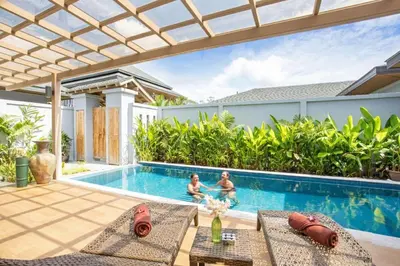 two children playing in the swimming pool of a villa at Luxury 2BR Pool Villa Dalaa 3, Gated Residence, Kamala Beach in Kamala Beach