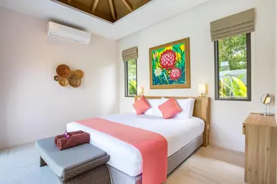 a bedroom with a bed and two windows at Luxury 2BR Pool Villa Dalaa 3, Gated Residence, Kamala Beach in Kamala Beach