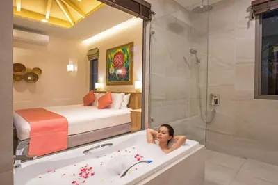 a woman laying in a bath tub in a hotel room at Luxury 2BR Pool Villa Dalaa 3, Gated Residence, Kamala Beach in Kamala Beach