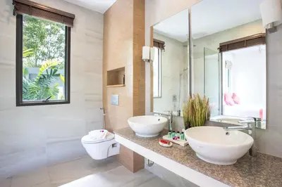 a bathroom with two sinks and a toilet at Luxury 2BR Pool Villa Dalaa 3, Gated Residence, Kamala Beach in Kamala Beach
