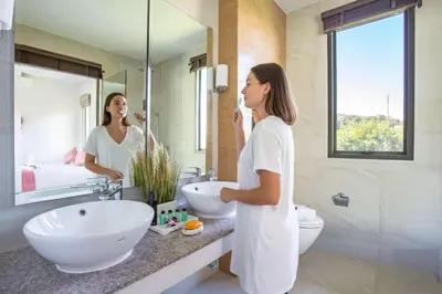a woman standing in front of a mirror in a bathroom at Resort Boutique 2BR Villa Dalaa 4, Private Pool, Full Service, 5 min Drive Kamala Beach in Kamala Beach