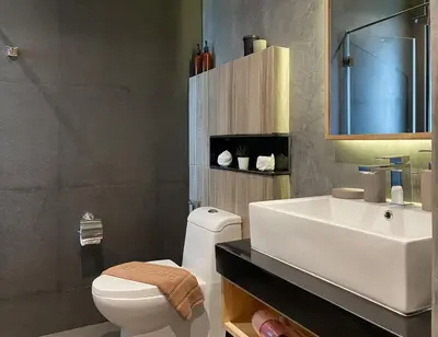 a bathroom with a white toilet and a sink at ReLife Windy Naiharn by Beringela in Nai Harn Beach
