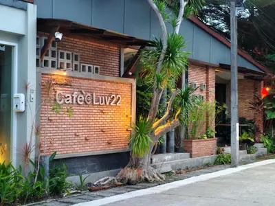 a brick building with a sign that reads cafe at Cafe'@luv22 in Phuket Town