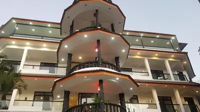 a large building with a clock on top of it at La Capannina Hotel Patong in Patong Beach