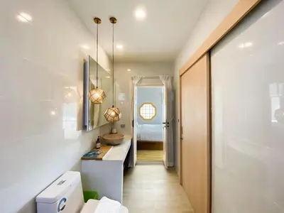 a bathroom with a sink and a toilet in a room at Wayla Villa@Maikhaobeach in Mai Khao Beach