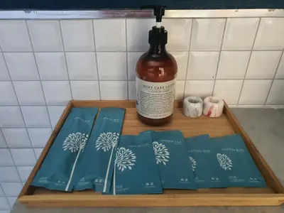 a wooden tray with books and a bottle of alcohol at Wayla Villa@Maikhaobeach in Mai Khao Beach