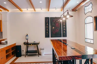 a kitchen with a wooden counter top in a room at Capzule Bed Phuket in Phuket Town