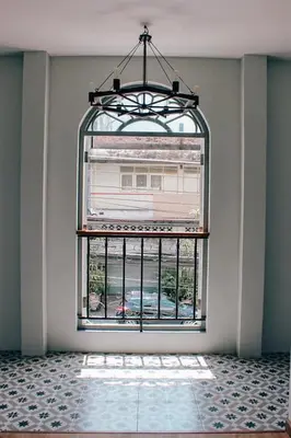 a room with a window with a view of a building at Capzule Bed Phuket in Phuket Town