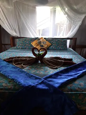 a ribbon is on top of a bed at Big Hug Home in Ko Yao Noi