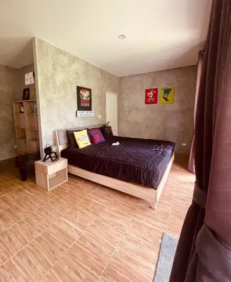 a bedroom with a bed in a room at Destination39 in Thalang