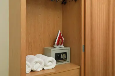 a room with towels on a shelf next to a microwave at Suite Cascade 2BR Family Deluxe Kamala Falls in Kamala Beach