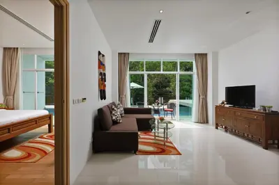 a living room with a couch and a tv at Suite Cascade 2BR Family Deluxe Kamala Falls in Kamala Beach
