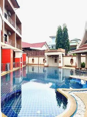 a swimming pool in the middle of a building at My Friend's House Karon in Karon Beach
