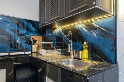 a kitchen with a sink and a blue wall at Bangla house with 4 houses Pick house before BOOK in Patong Beach
