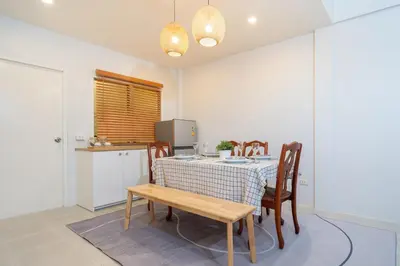 a dining room with a table and chairs and a kitchen at Bangla house with 4 houses Pick house before BOOK in Patong Beach