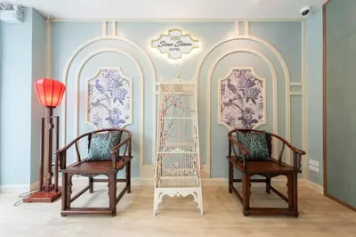 two chairs in a room with two mirrors at Sino Siam Hotel in Klong Muang Beach
