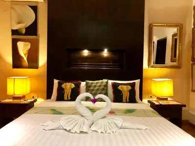 two swans making a heart shape on a bed at Baipho Lifestyle in Patong Beach