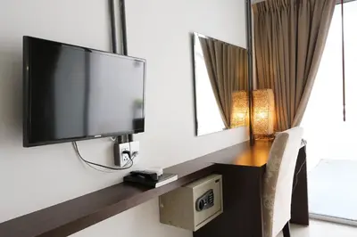 a flat screen tv on a wall in a room at The Nest Resort Patong in Patong Beach