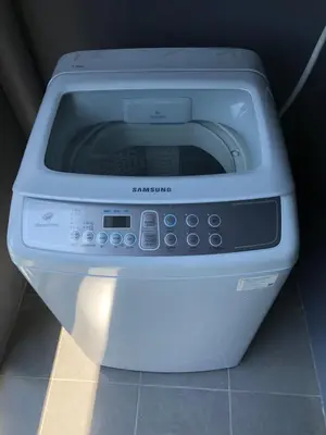 a white microwave sitting on top of a counter at Aristo Resort Surin Beach K5 in Phuket Town