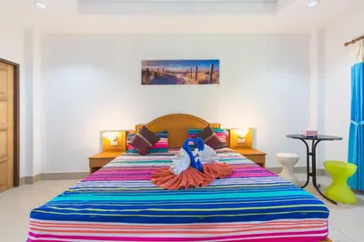 a bedroom with a colorful bed with a doll on it at Grand View in Patong Beach