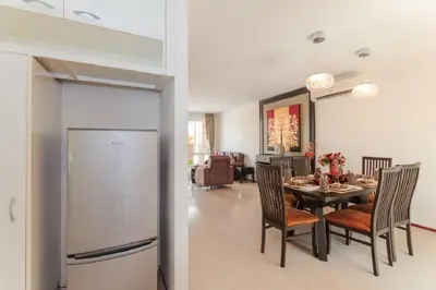 a kitchen and dining room with a table and chairs at Genesis Villas in Rawai Beach