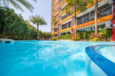 a swimming pool in front of a building at SOLA Condo 1BR Tropical View NBC Nai Harn Nai in Rawai Beach