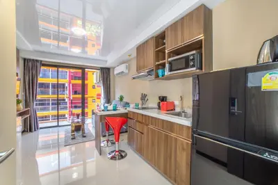a kitchen with a red stool in the middle of it at SOLA Condo 1BR Tropical View NBC Nai Harn Nai in Rawai Beach
