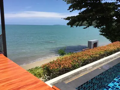 a view of the ocean from a house balcony at Koh Sirey Beachfront Pool Villa in Phuket Town