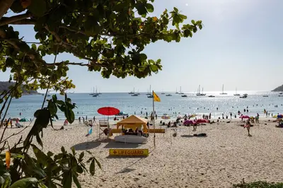 a group of people on a beach with the water at Relife Windy by Holy Cow, country view in Rawai Beach