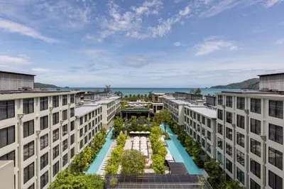 an apartment building with a garden in the middle at Four Points by Sheraton Phuket Patong Beach Resort in Patong Beach